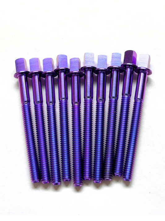 Set of colourful titanium drum tension rods on white background